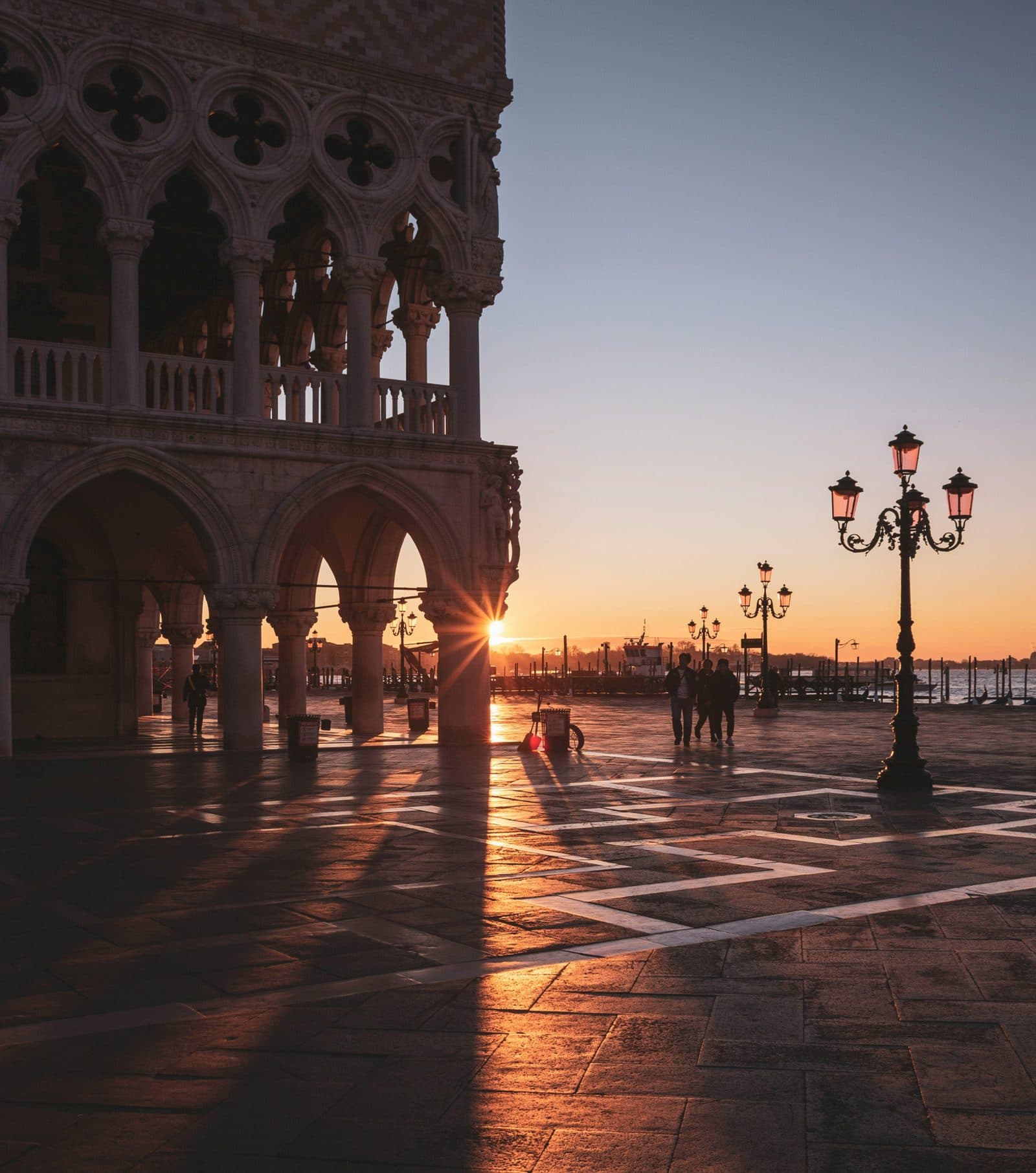 Sunrise over Piazza San Marco, Venice, with the arcades of the Doge’s Palace in silhouette