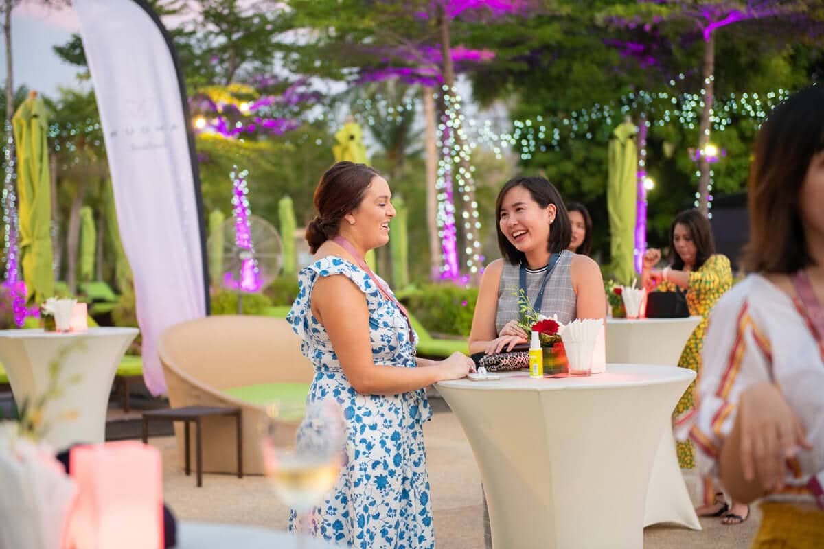 Delegates chatting at an outdoor evening reception