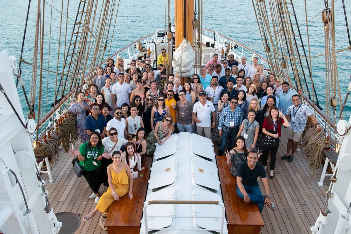 Group photo of Amour delegates on the deck of a tall ship