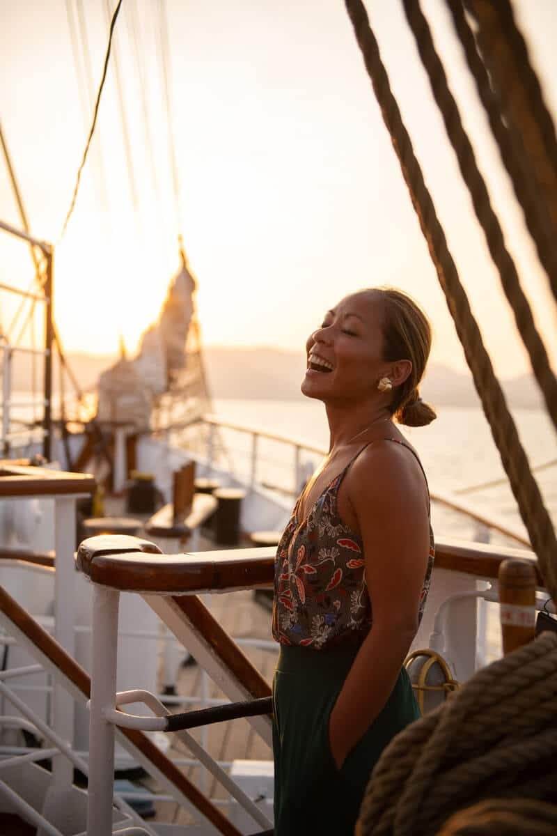 Delegate smiling on a sailing ship at sunset