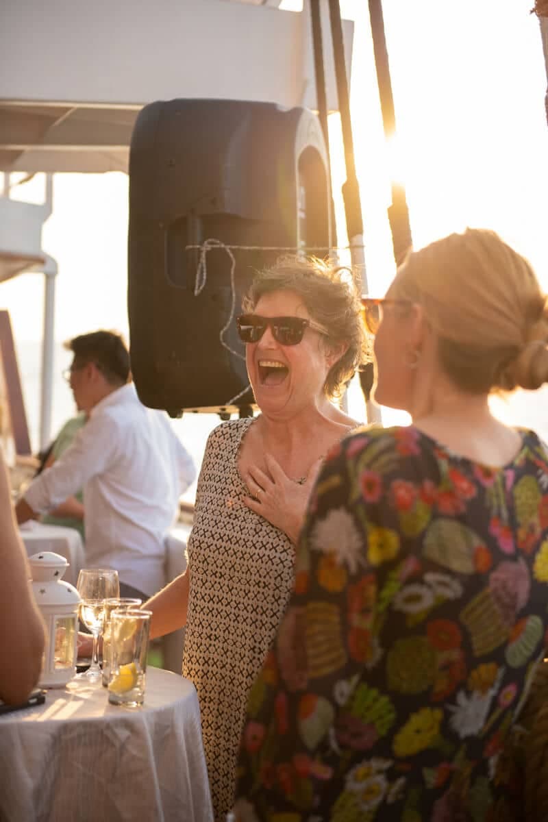 Delegates laughing at a sunset party