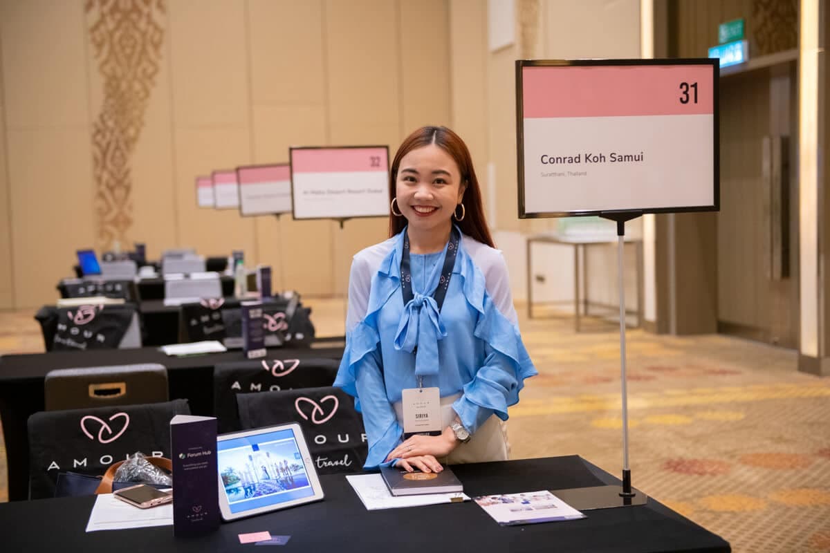 Exhibitor smiling at her Amour meeting table