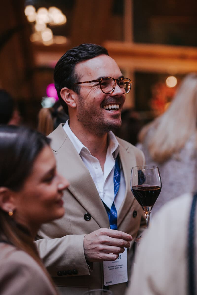Delegate laughing with a glass of red wine