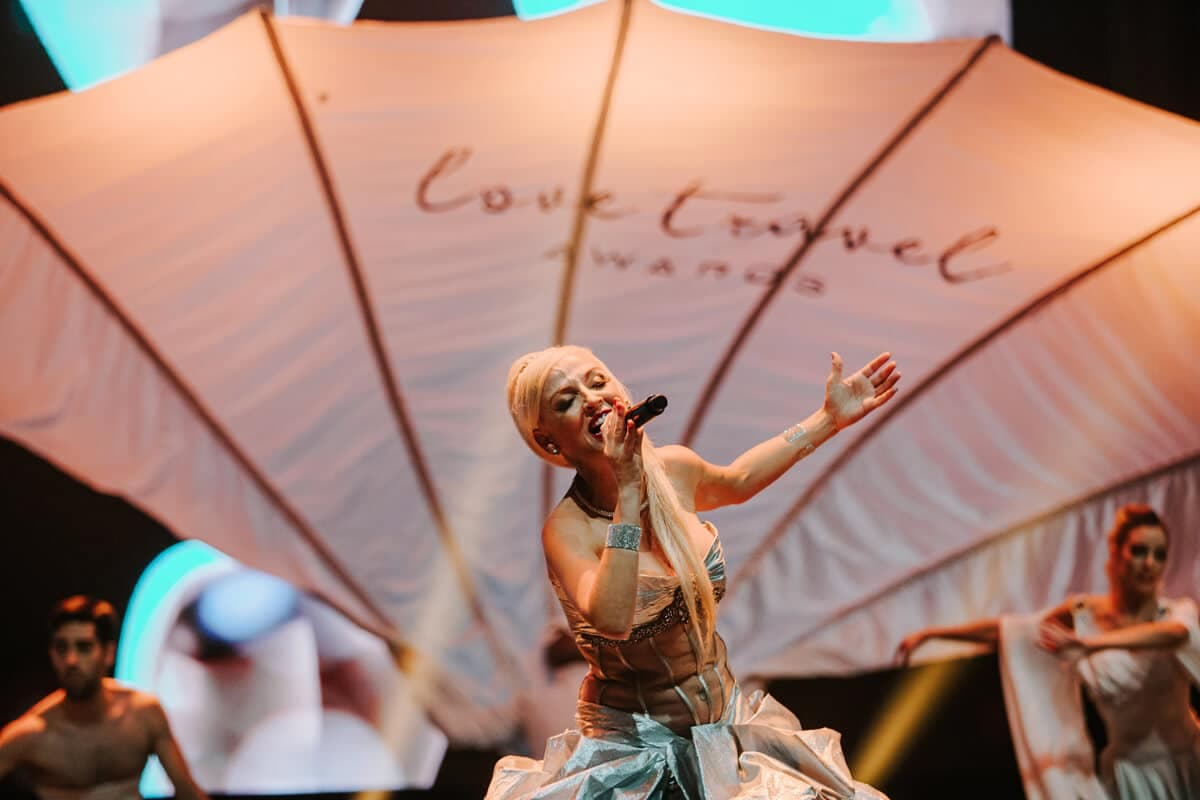 Performer on stage at the Love Travel Awards