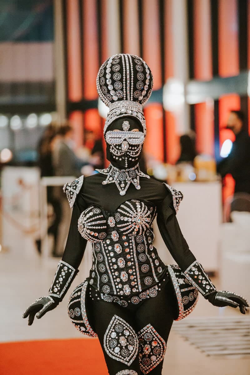 Costumed performer in black and white at an Amour event