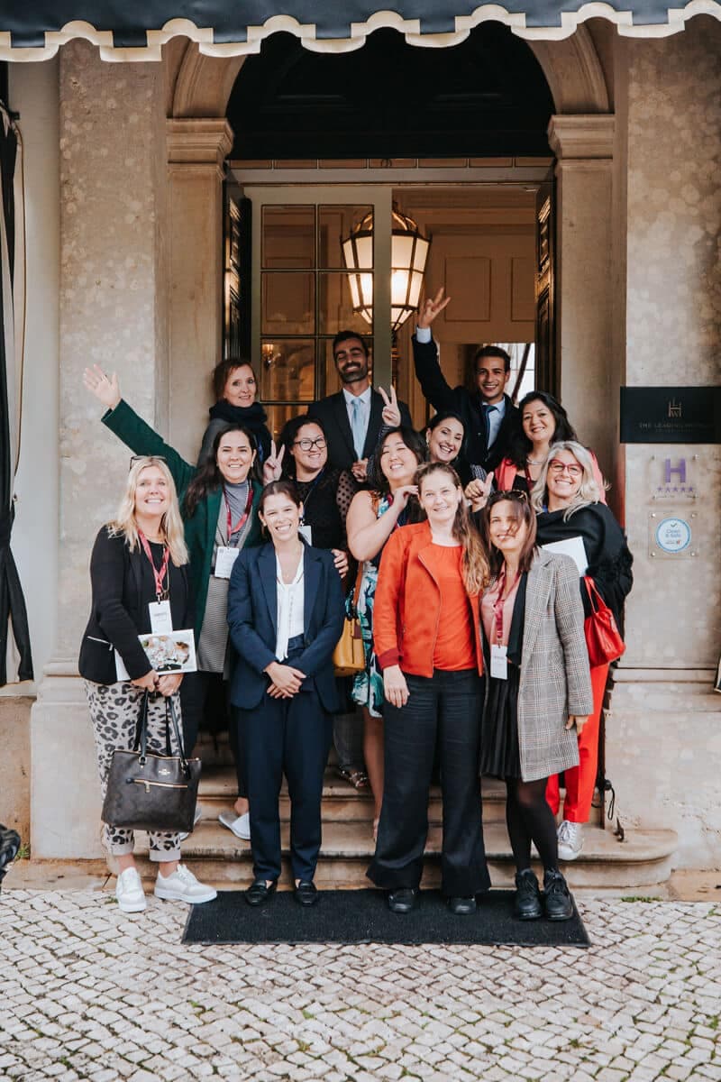 Group of delegates on the steps of a hotel entrance