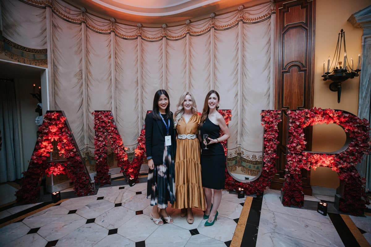 Delegates posing among giant floral AMOUR letters