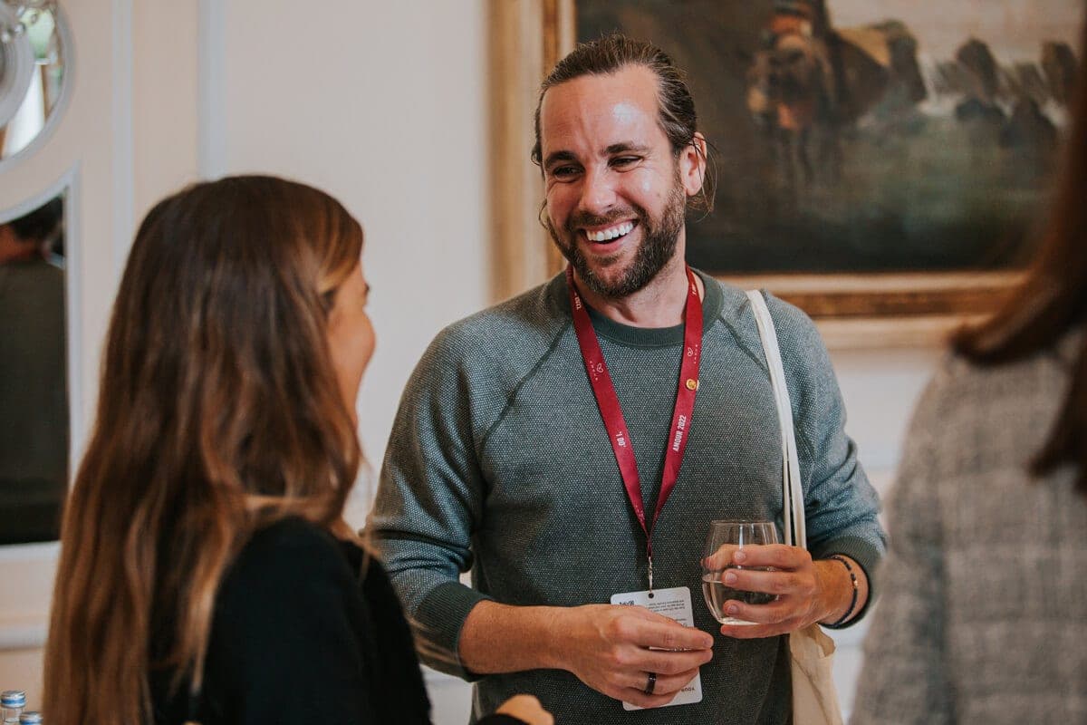 Two delegates chatting and laughing at a reception