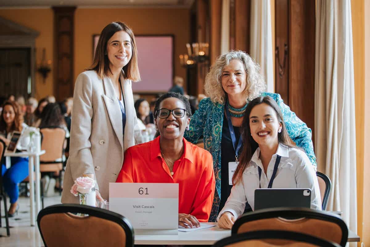 Delegates smiling together at a meeting table