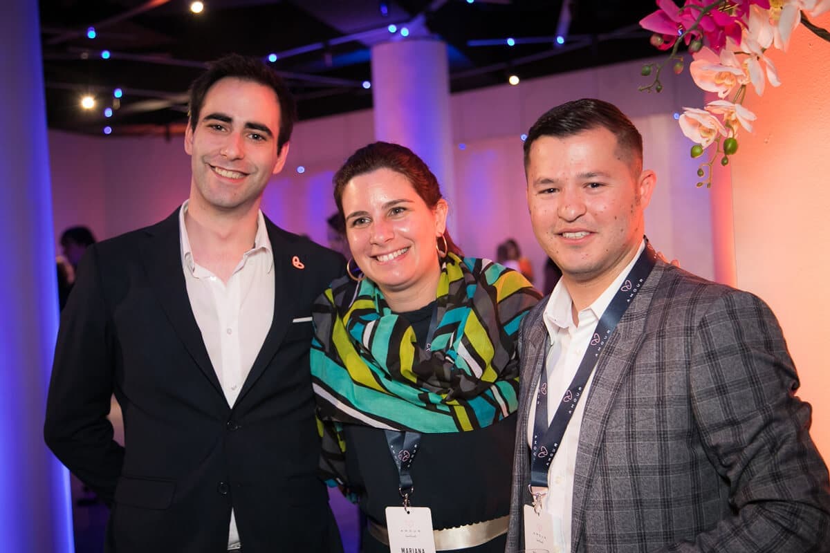 Three delegates posing at an evening reception