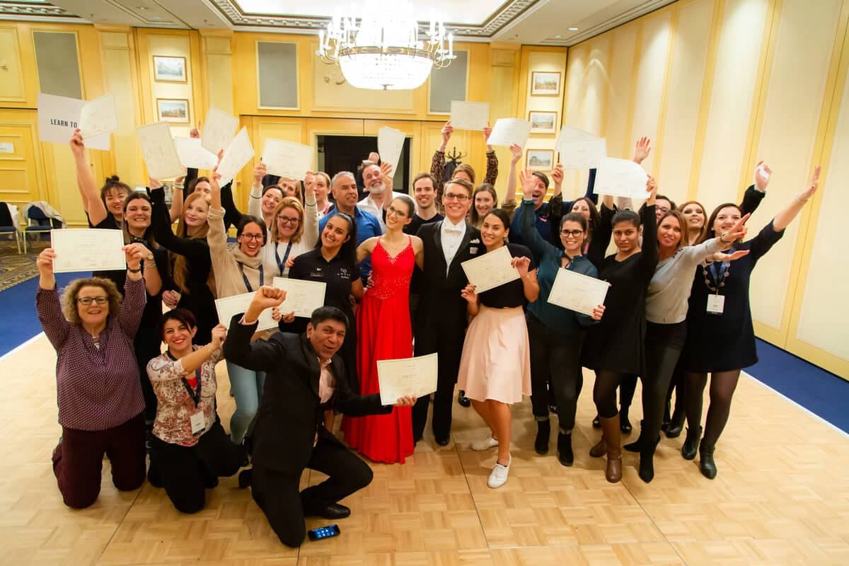 Delegates celebrating together in a ballroom